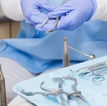 Dentist holding dental tools.